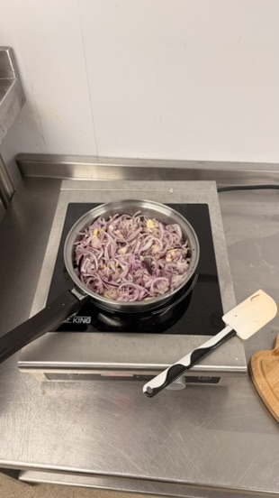 Onions and shallots sweating in a pan